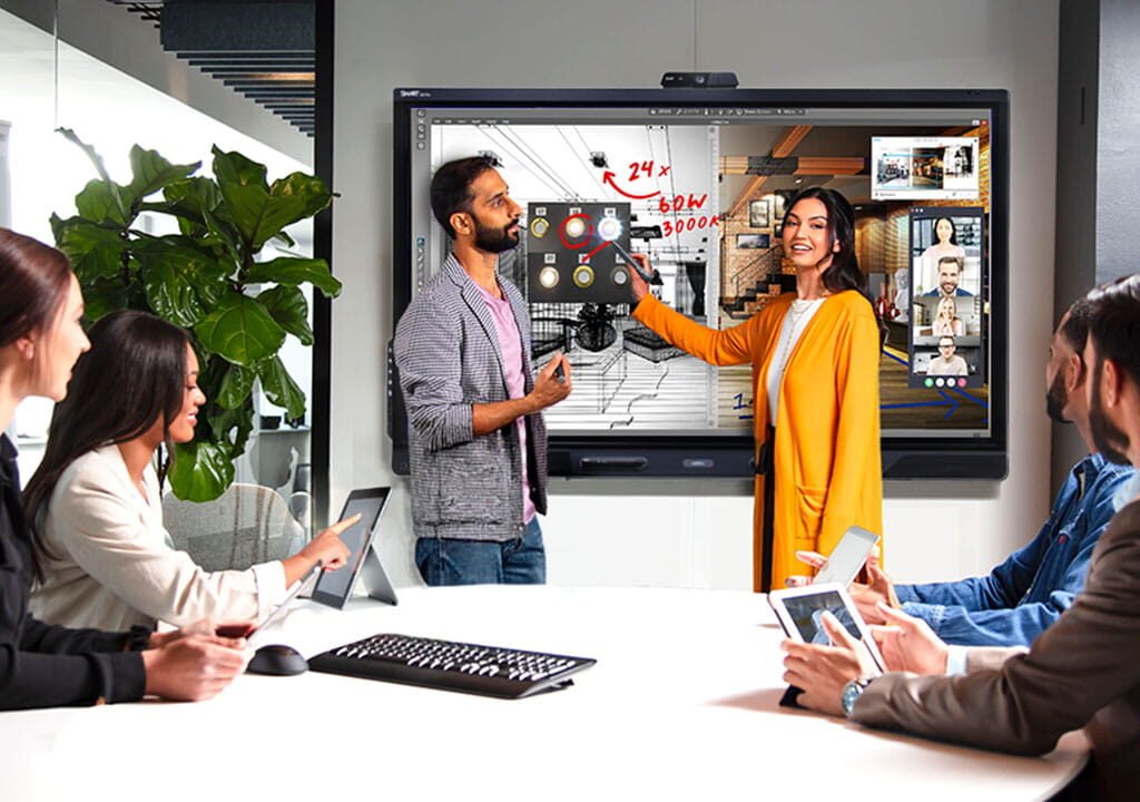 FavortechIT team collaborating in a modern office, presenting IT services, AI automation, digital marketing, and cybersecurity solutions on a smart interactive board.